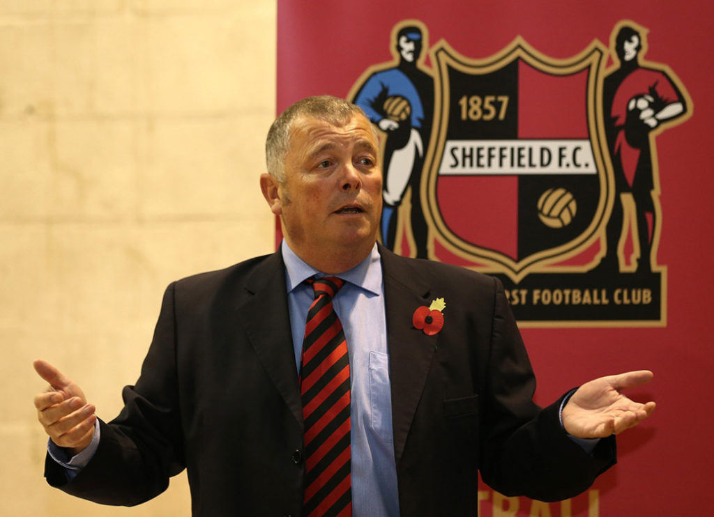 Photo of Richard Tims with Sheffield FC logo in background