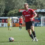 Male Sheffield FC player preparing to kick ball