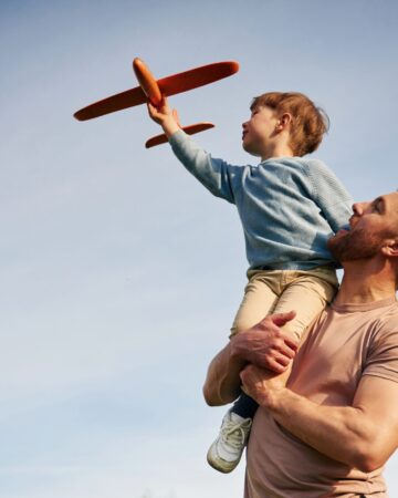 Blue,Sky,With,White,Cloud.,Father,Is,Holding,Son,That