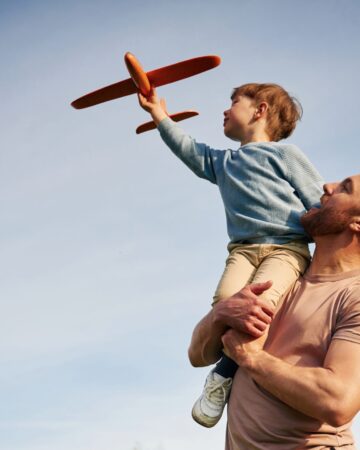 Blue,Sky,With,White,Cloud.,Father,Is,Holding,Son,That