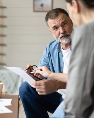 Middle,Aged,Senior,Old,Couple,Holding,Documents,Reading,Paper,Bills