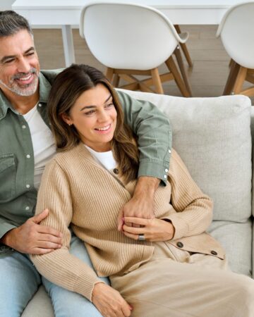 Happy,Middle,Aged,Mature,Couple,Hugging,Looking,Away,Relaxing,On