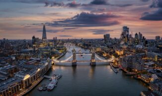 Aerial,View,Of,The,Illuminated,Tower,Bridge,And,London,Skyline